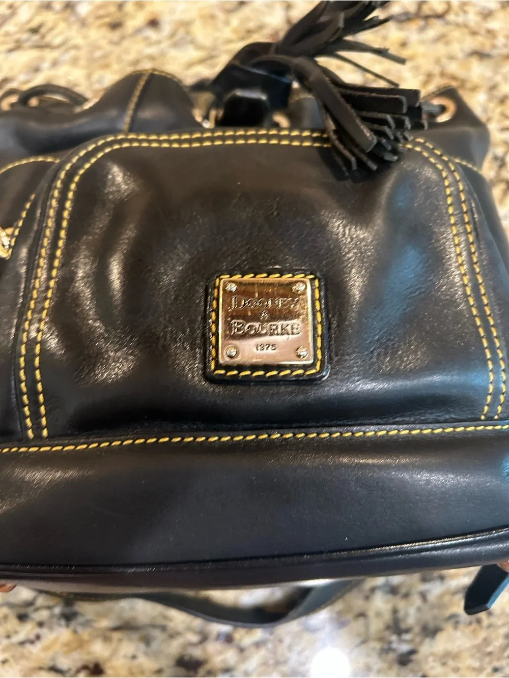 Dooney & Bourke Black Leather Drawstring Backpack with Yellow Stitching